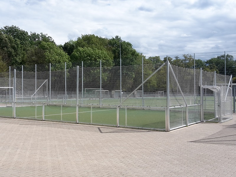 Soccer court with glazed barrier